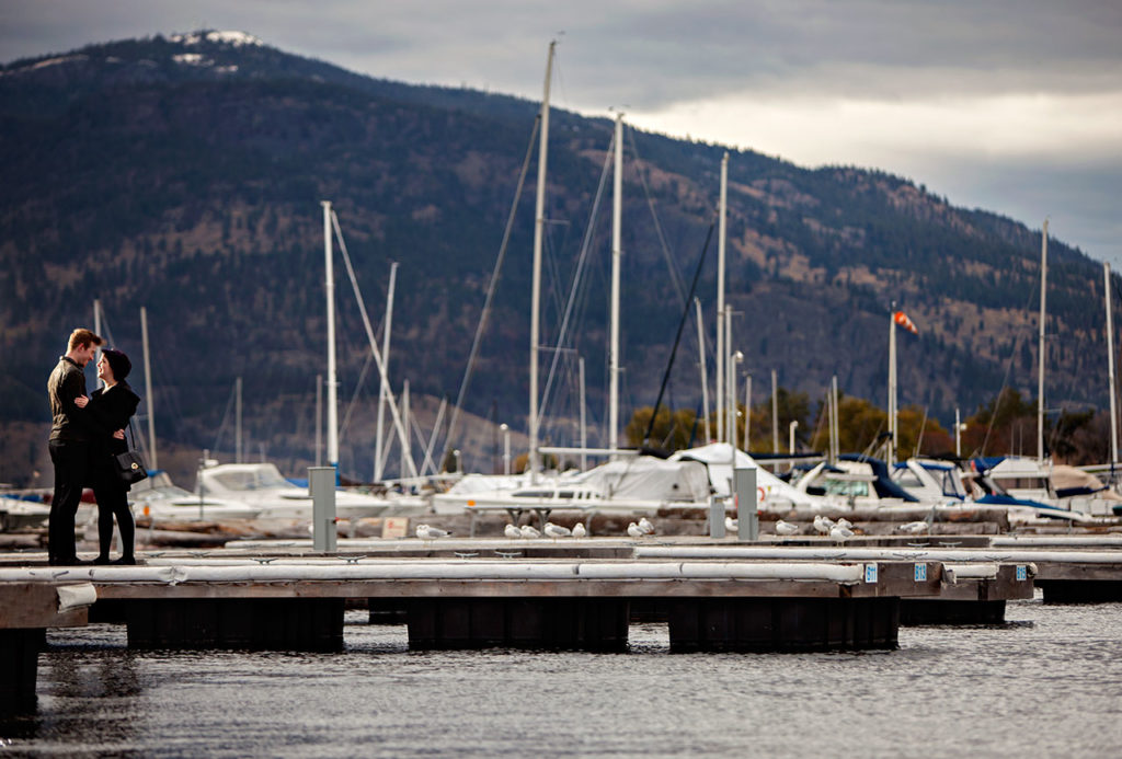 Boats floating on the waiter in Marina Kelowna while couple looking at each other